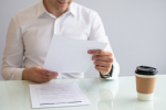 close-up-smiling-young-businessman-looking-document (1).jpg
